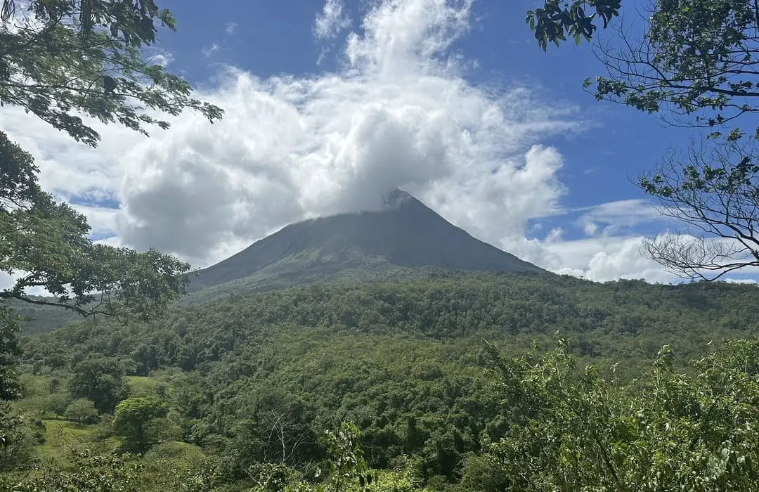 Scenic view of the Tenorio Volcano peak surrounded by lush tropical rainforest in Costa Rica.